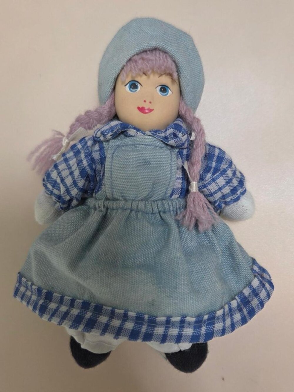Little doll with braids and ceramic head